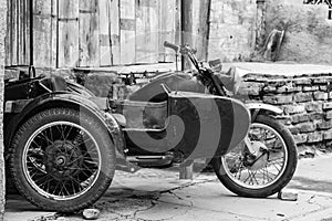 Old motorcycle in Santiago de Cuba, dark Motorbike with sidecar. Black and white photography