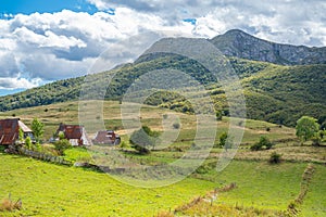 An old mountain village with roofs made of cut old barrels with a beautiful view of the landscape