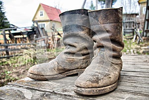 Old muddy farmers boots