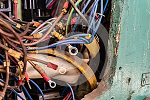 Old multicolored wires in the electrical cabinet of mechanical equipment.