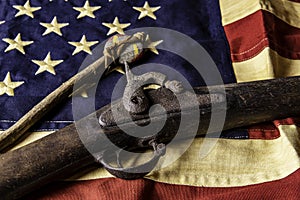 Old musket gun on American flag