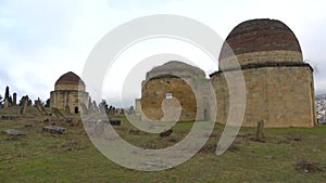 Old Muslim mausoleum of the complex of Eddie Gumbez, cloudy january day. Shamakhi, Azerbaijan