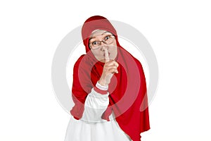 Old muslim woman showing silence gesture