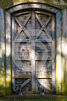 An old mysterious door in the garden. Overgrown Secret Garden Door.