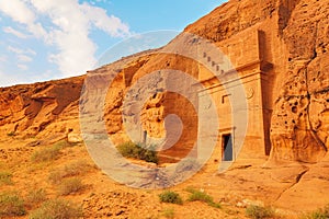 Old Nabatean architecture carved on orange sandstone wall at Jabal Al Ahmar, Hegra in Saudi Arabia, 18 ancient tombs are