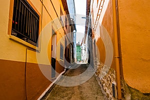 Old and narrow alleyway along the buildings of La Vall d'Ebo in Alicante, Spain