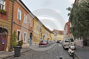 Old narrow street with parked cars in Budapest, Hungary.