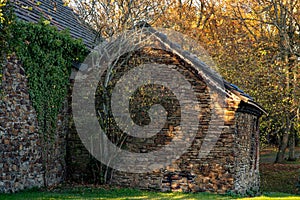 Old natural stone house in golden evening sunlight