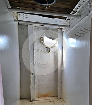 Old Nautical Porthole on a Ship with Brilliant Light Shining