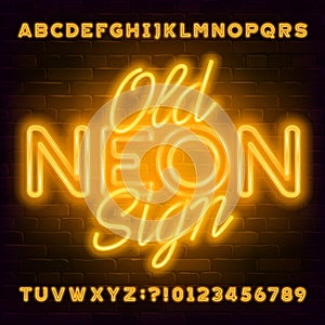 Old Neon Sign alphabet font. Yellow neon light letters and numbers on brick wall background.