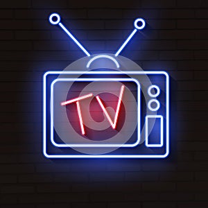 Old neon TV with antenna on brick wall