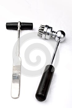 Old neurologist`s malleus and  acupuncture hammers for chinese plum therapy on a white background.