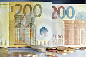 Old and New 200 Euro banknotes. European Union Money Currency. Yellow Banknotes from ECB. Coins in front