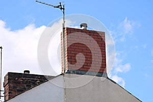 CHIMNEY STACK AGAINST A BLUE AND WHITE SKY