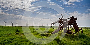 Old and new technology - wind turbines and abandoned plough