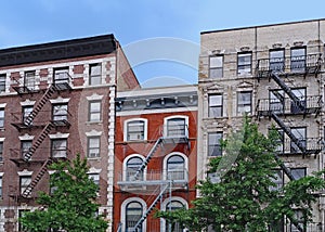 Old New York apartment building with external fire escapes,