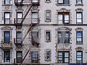 Old New York apartment building with external fire escapes,