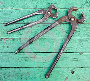 Old nippers on wooden background