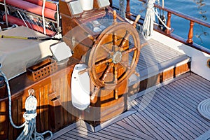 Old nostalgic sail boat - cockpit and rudder of teak wood.