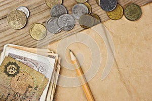 Old notes and coins and pencil
