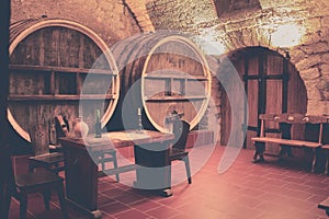 Old oak barrels in an ancient wine cellar.