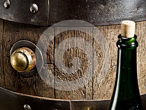 Old oak wine barrel and wine bottle.