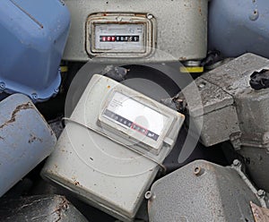 Old obsolete disused gas counters in a landfill of toxic waste