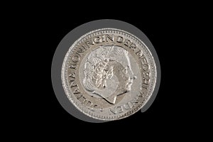 An old one Dutch guilder coin on black