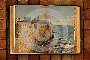 Old open book. Ancient arab city of Acre, Akko. View on  historical fortification. Mediterranean, Israel.
