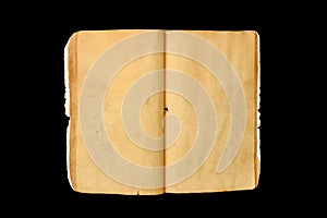 An old open book with blank yellow stained pages isolated on black background
