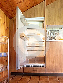 Old fridge in a dated kitchen