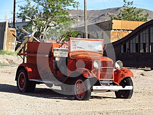 Old Open Top Red Orange Truck Parked in a Dirt Lot, Goldfield, Nevada