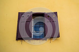 Open window on a yellow wall