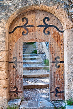 Old open wooden door with stairs