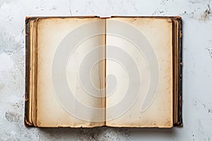 Old opened book with blank pages on white gray marble background. Top view. Mockup template book page with copy space