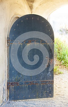 Old opened metal door in a medieval castle close up