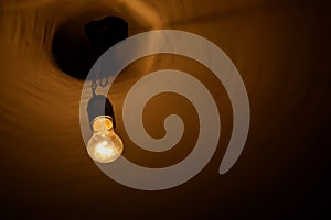 Old orange light bulb on the ceiling