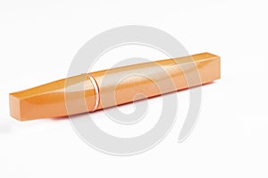 Old orange mascara isolated on white background. Copy space