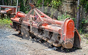 Old orange rotary cultivator