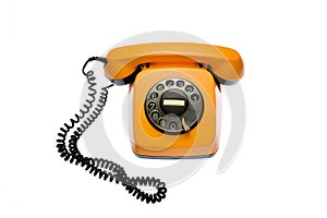 Old, orange rotary dial telephone, isolated on white background