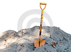 Old orange shovel On the pile of sand isolated on white background.