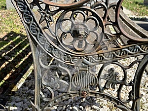 Old ornate metal bench in the public cemetery