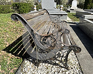 Old ornate metal bench in the public cemetery