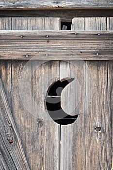 Old outhouse, crescent moon door photo