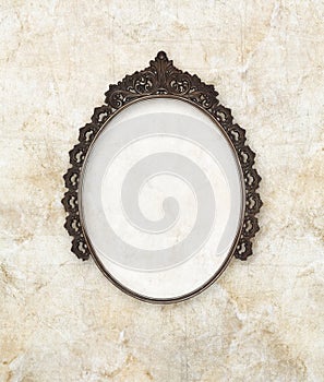 Old oval picture frame metal worked on marble background