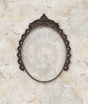 Old oval picture frame metal worked on marble background