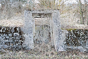 Old overgrown concrete gate no trespassing