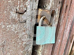 Old padlock. Background with old blue door lock