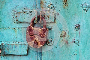 Old padlock on a blue door photo