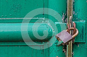 Old padlock on the gate, Rusty metal.